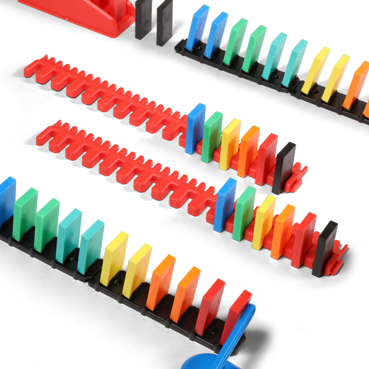 Atwood Toys Bulk Dominoes Rapid Track Kit close-up of red Speed Templates aligning multi-color dominoes for precision spacing and quick line setup