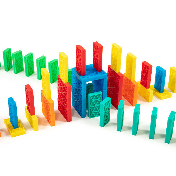 Bulk Dominoes Kinetic Dominoes arranged in a creative 3D wall structure with colorful red, blue, yellow, green, teal, and orange pieces from the Ultimate Starter Kit 101.