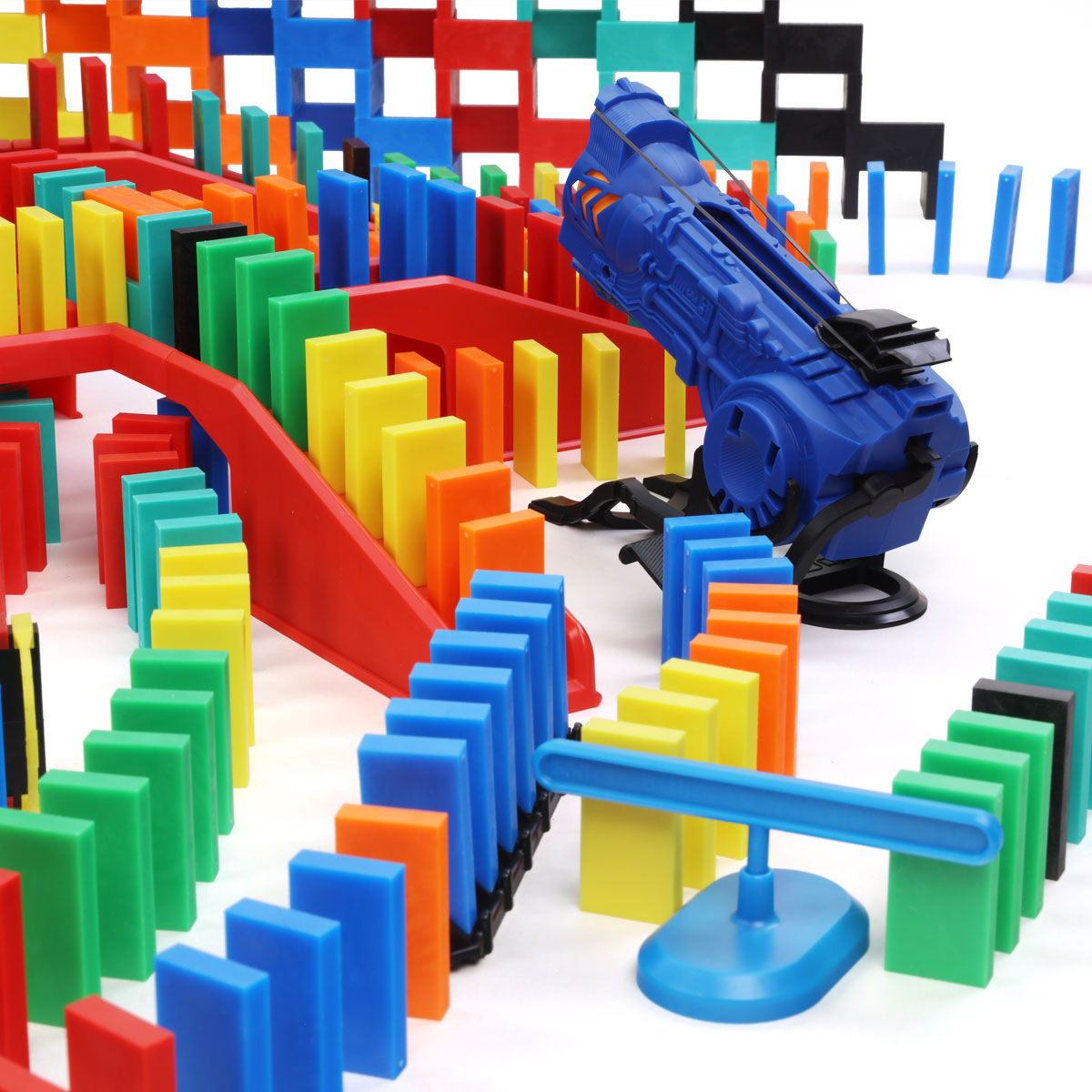 Atwood Toys Bulk Dominoes Pro Master Builder Kit close-up of the blue BD5000 Launcher accessory positioned among multi-color Pro-Dominoes and red staircase bridges