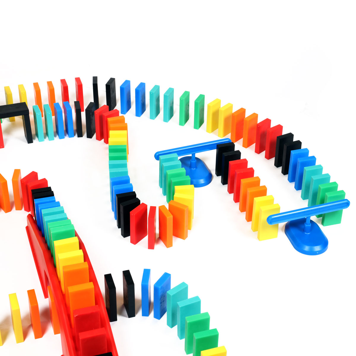 Bulk Dominoes Expert Kit blue domino spinners holding rainbow Pro Dominoes in a curved chain reaction layout with red kinetic speed templates from Atwood Toys.