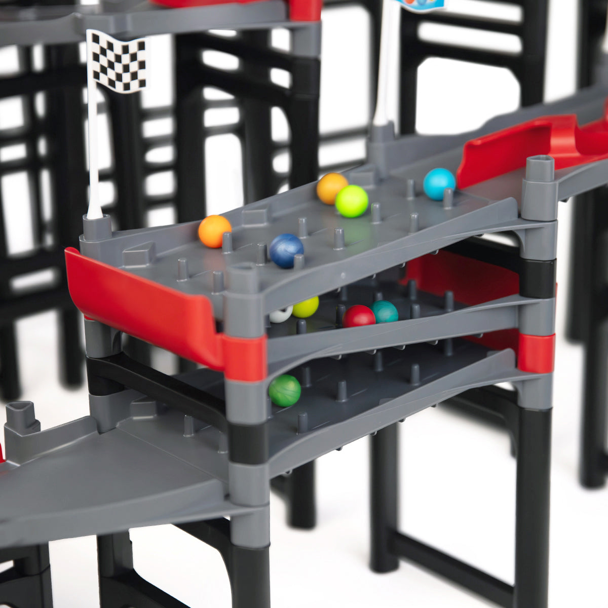 IMR Grand Prix Redline close-up of multi-level impact zone peg sections with colorful marbles racing across stacked gray lanes and red dividers
