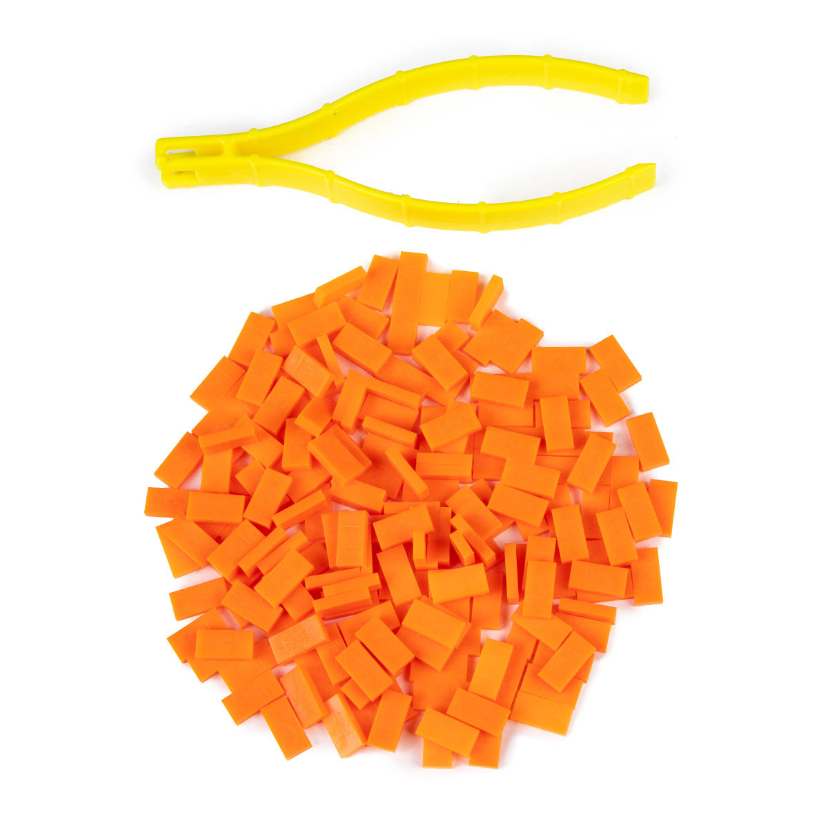 Atwood Toys World Record Mini Micro Dominoes in neon orange piled together with yellow precision tweezer setup tool for tiny domino toppling builds