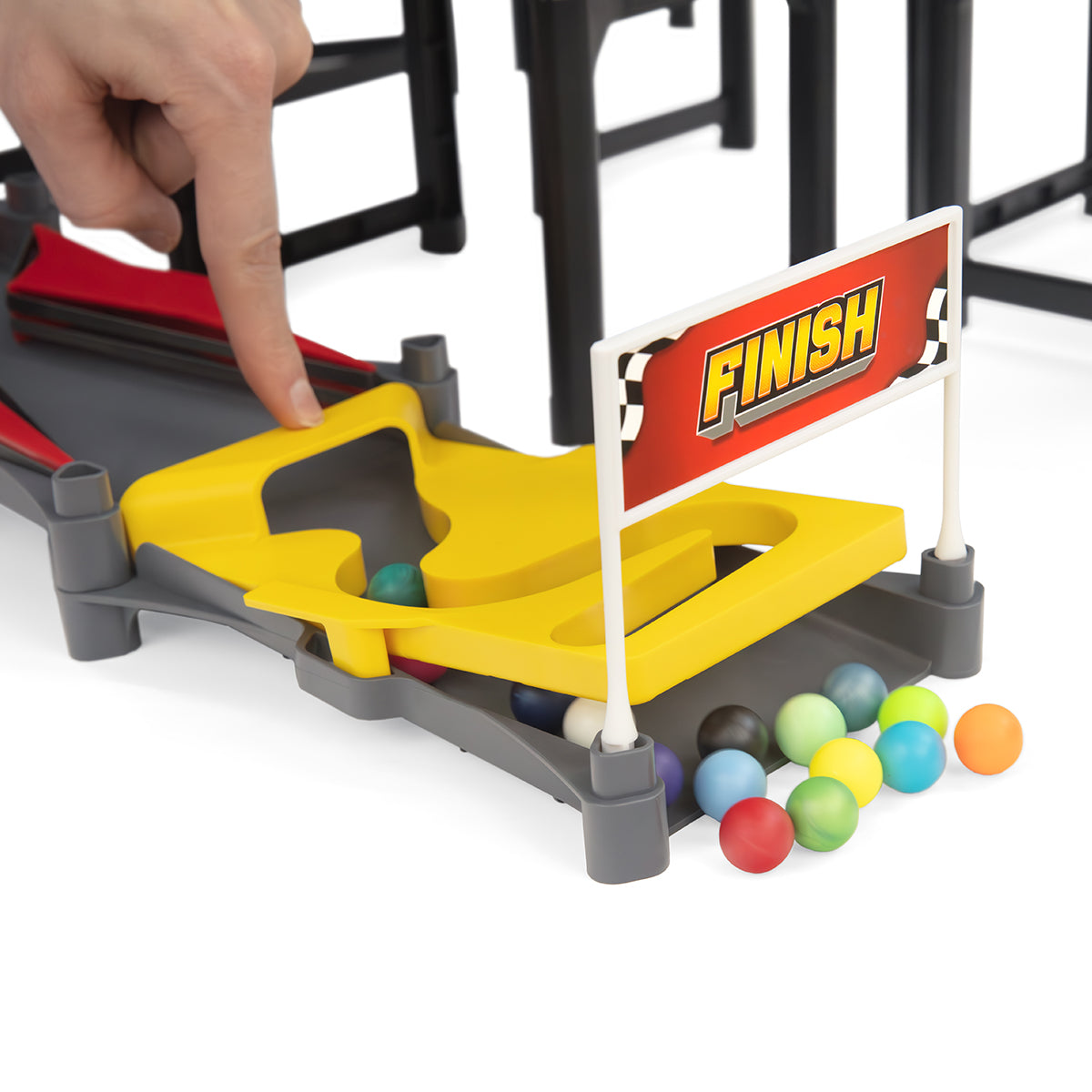 IMR Speedway Redline finish line close-up with hand placing marble and colorful marbles collected at yellow base