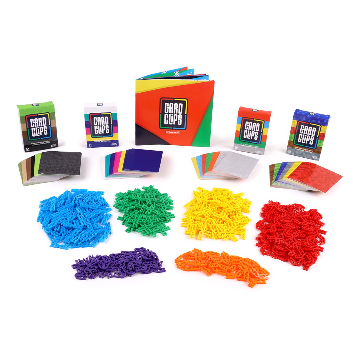 Card Clips Super Spectrum Kit from Atwood Toys, with piles of blue, green, yellow, red, purple and orange plastic connector clips, stacks of printed building cards, and the rainbow instruction booklet and card decks that link cards into towers, bridges and 3D structures.
