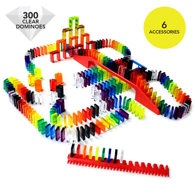 Bulk Dominoes Artisan Kit complete setup with 300 clear dominoes and 6 accessories badge overlay showing domino chain reaction with bridge, tower, and straight track