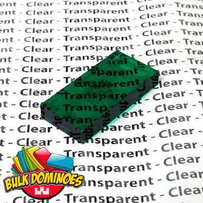 Close-up of a single translucent clear jade green Bulk Dominoes Clear Jade Pro Domino resting on a printed background reading Clear and Transparent, showing the see-through tile.