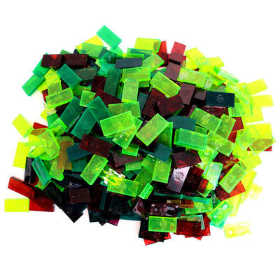 Bulk Dominoes closeout dominoes pile showing a translucent color lot with clear green, neon yellow, and dark red Pro Dominoes