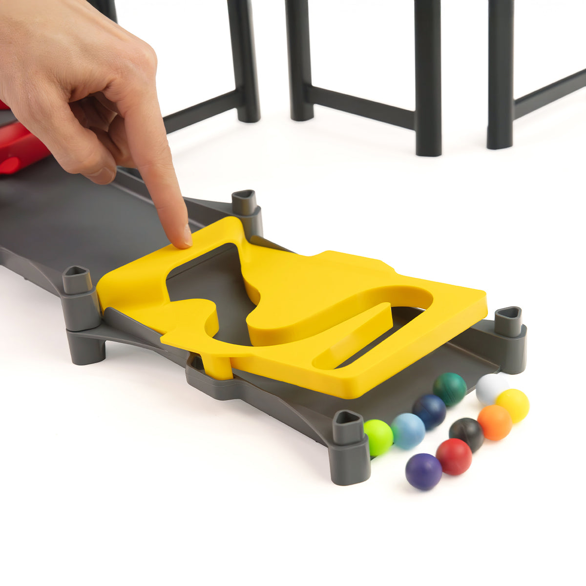 IMR Circuit Redline finish line piece with hand pressing trap door and colorful marbles lined up below