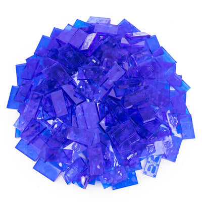 Bulk Dominoes Clear Blue Pro Dominoes from Atwood Toys, a top-down pile of translucent clear blue full-weight toppling dominoes for chain reactions and domino art.