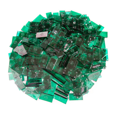 Bulk Dominoes Clear Jade Pro Dominoes from Atwood Toys, a top-down pile of translucent clear jade green full-weight toppling dominoes for chain reactions and domino art.
