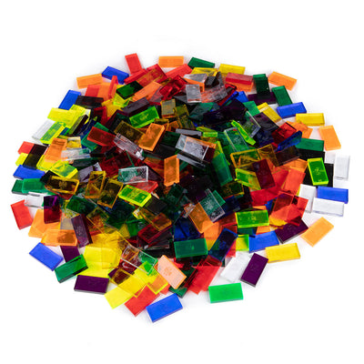 Angled pile of translucent Bulk Dominoes Clear Assorted Colors Pro Dominoes from Atwood Toys in clear red, orange, yellow, green, blue, purple, and white.
