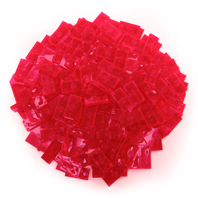 Bulk Dominoes Clear Neon Pink Pro Dominoes from Atwood Toys, a top-down pile of translucent neon pink full-weight toppling dominoes for chain reactions and domino art.
