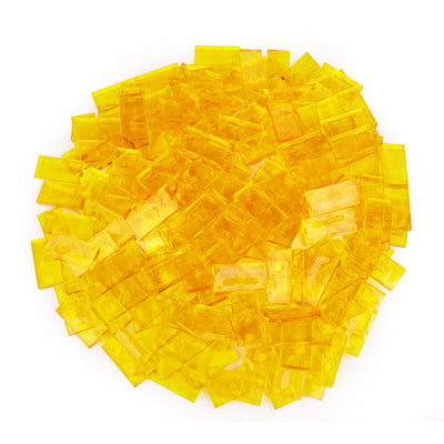 Bulk Dominoes Clear Honey Pro Dominoes from Atwood Toys, a top-down pile of translucent honey yellow full-weight toppling dominoes for chain reactions and domino art.