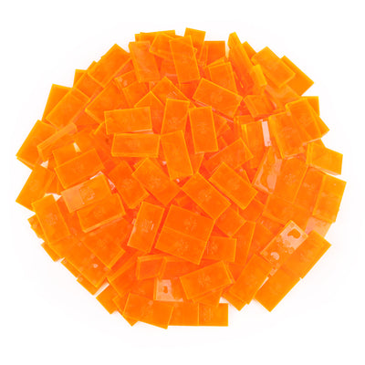 Bulk Dominoes Clear Orange Pro Dominoes from Atwood Toys, a top-down pile of translucent clear neon orange full-weight toppling dominoes for chain reactions and domino art.