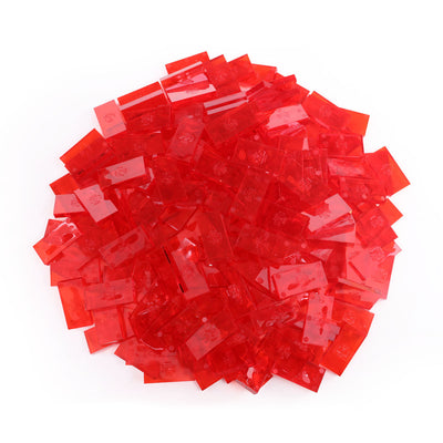 Bulk Dominoes Clear Red Pro Dominoes from Atwood Toys, a top-down pile of translucent clear red full-weight toppling dominoes for chain reactions and domino art.