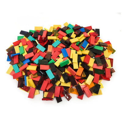 Bulk Dominoes closeout dominoes pile showing a solid color lot with mixed Pro Dominoes in red, yellow, black, teal, blue, green, and orange