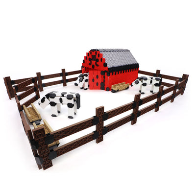 Red barn and brown fenced pasture with black-and-white cows, all built from the Atwood Toys Constructix Creative Explorer set, demonstrating thematic farm-scene building