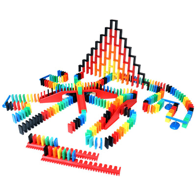 Bulk Dominoes Expert Kit from Atwood Toys with rainbow Pro Dominoes arranged in a fire tower setup, surrounded by red kinetic speed templates, support posts, and accessories.