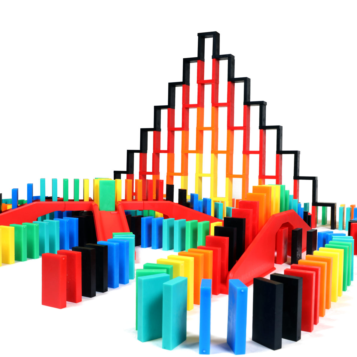 Bulk Dominoes Expert Kit fire tower setup with rainbow Pro Dominoes arranged in a pyramid backdrop, surrounded by red bridges and multicolor dominoes from Atwood Toys.