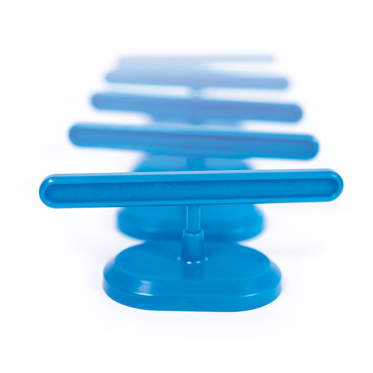Atwood Toys Bulk Dominoes blue Domino Spinner accessory in motion-blur action shot, showing the spinning paddle that changes direction in domino chain reactions and toppling builds