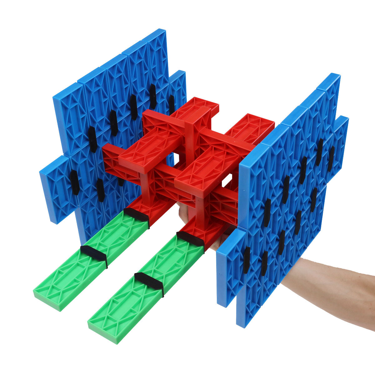 Spaceship structure built from blue panels, a red core, and green blocks held in hand, made from large interlocking Blokix building blocks from Atwood Toys