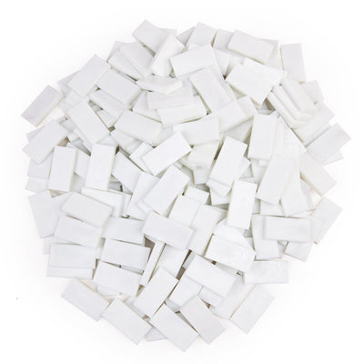 Bulk Dominoes Glow-in-the-Dark Pro Dominoes from Atwood Toys, a top-down pile of full-weight toppling dominoes glowing bright green in the dark for chain reactions and domino art.