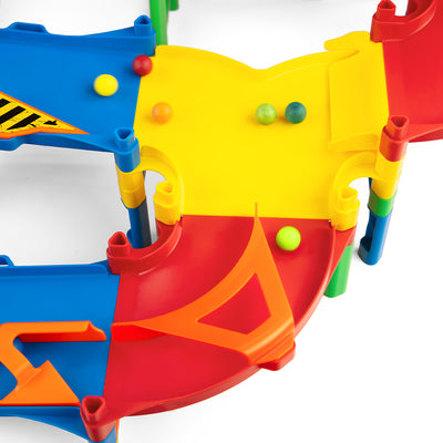 IMR Grand Prix Overdrive close-up of yellow and orange merger funnel piece with colorful marbles rolling down from blue upper lanes into merged red lower track section