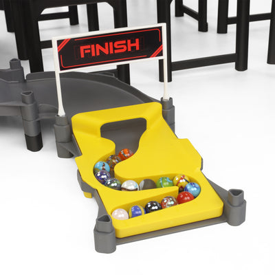 Jelle's M1 Hyper Loop close-up of yellow finish line gate with FINISH banner and Jelle's official glass marbles collected in the catch basin after a race