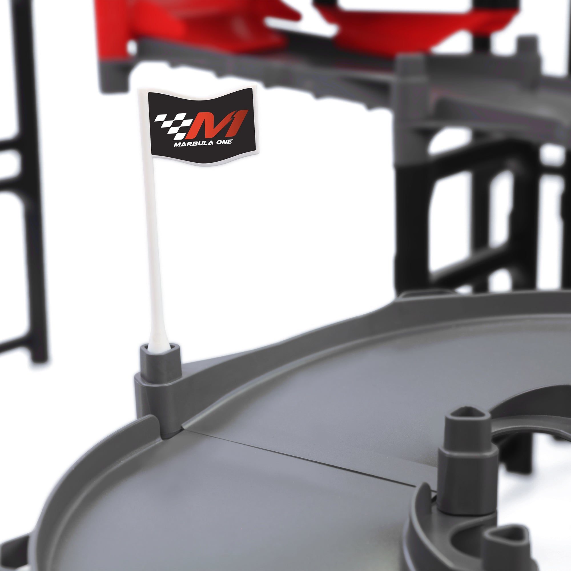 Jelle's M1 Hyper Loop close-up of Marbula One branded flag mounted on gray track section with red bumper and black support structure in background