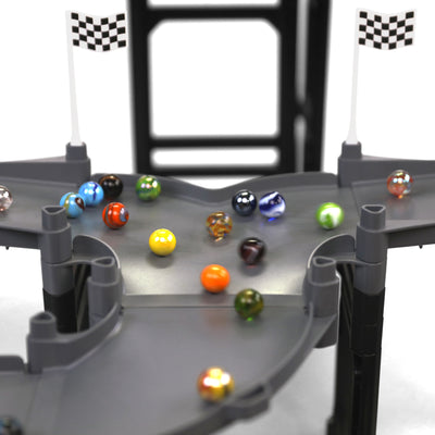 Jelle's M1 Hyper Loop close-up of merger section with Jelle's official glass marbles colliding and funneling together on gray track between two checkered flags