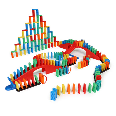Atwood Toys Bulk Dominoes Ultimate Kinetic Toppling Kit setup featuring a multi-color pyramid build, red staircase bridges, blue spinner, and colorful Pro-Scale dominoes arranged in a flowing chain reaction layout