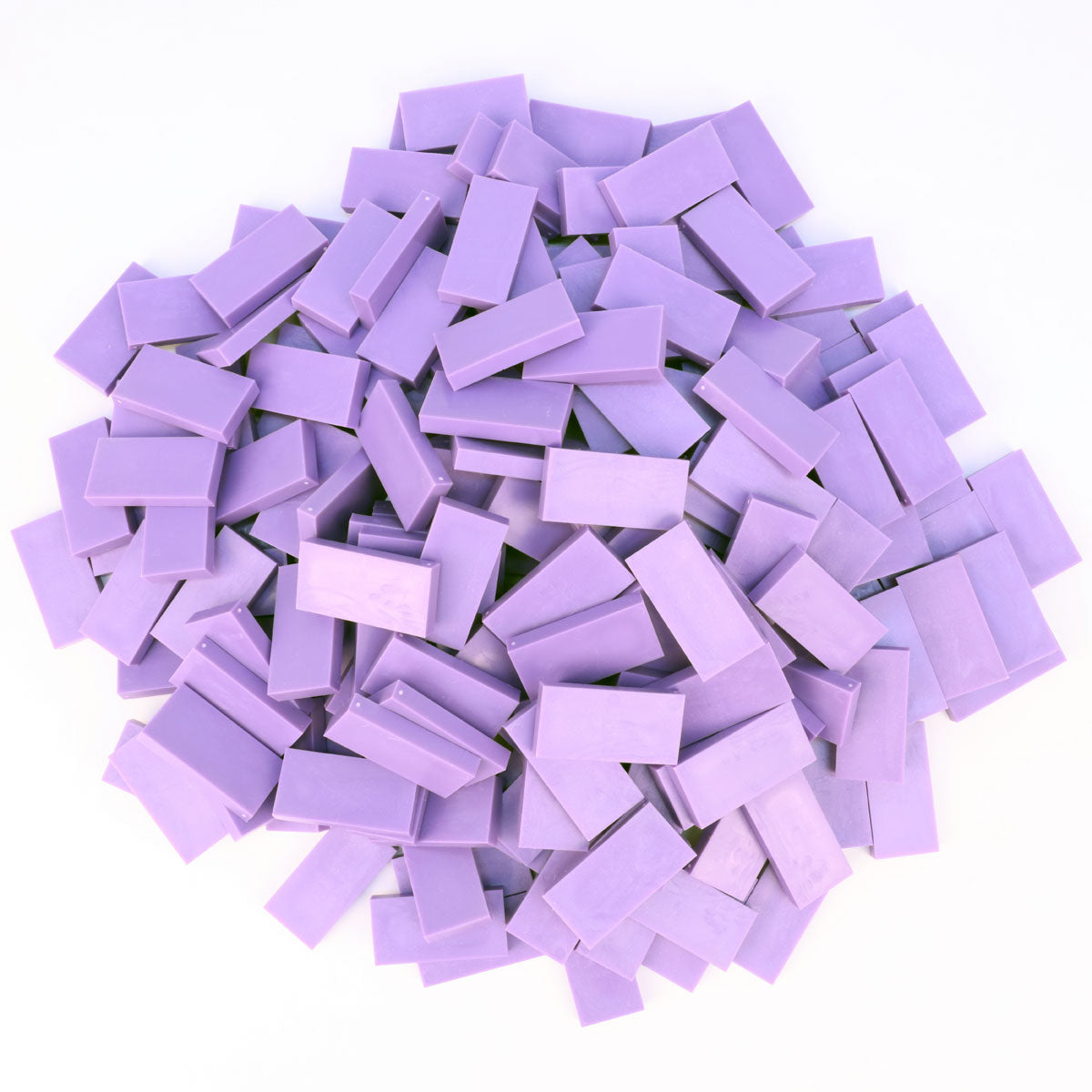 Bulk Dominoes Lilac Pro Dominoes from Atwood Toys, a pile of light purple full-weight toppling dominoes for chain reactions and domino art.