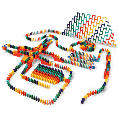 Bulk Dominoes Master Builder Kit full setup on white background with 1,000 colorful Pro Dominoes arranged in chain reaction paths, red bridges, stacked domino walls, and splitter sections