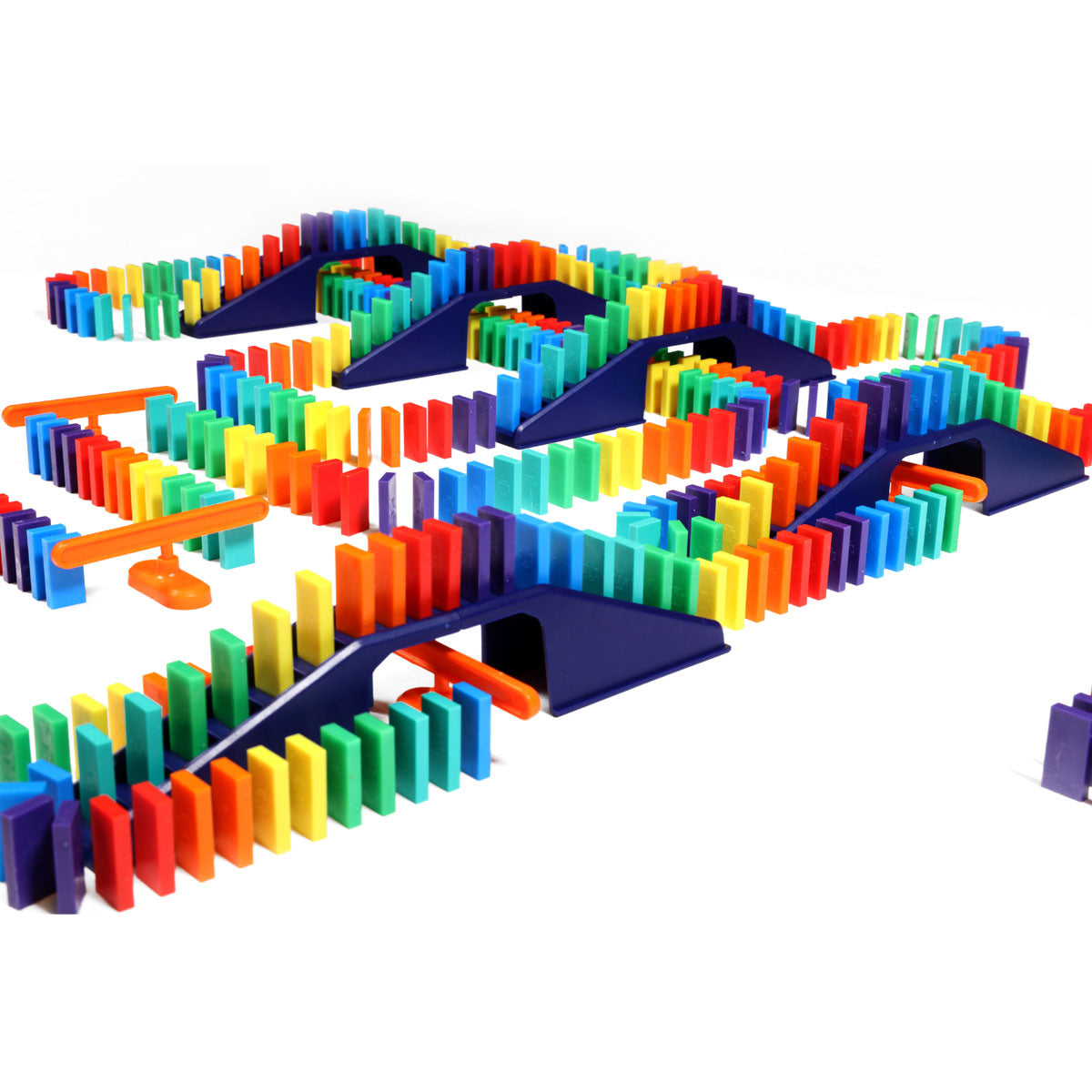 Bulk Dominoes Mini Master Kit close-up showing rainbow Mini Dominoes weaving across navy blue bridges with orange support pieces for elaborate chain reaction designs.