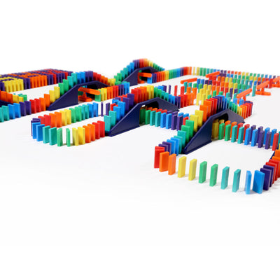 Bulk Dominoes Mini Master Kit close-up showing rainbow Mini Dominoes flowing across navy blue bridges and ramps in an elaborate chain reaction layout.