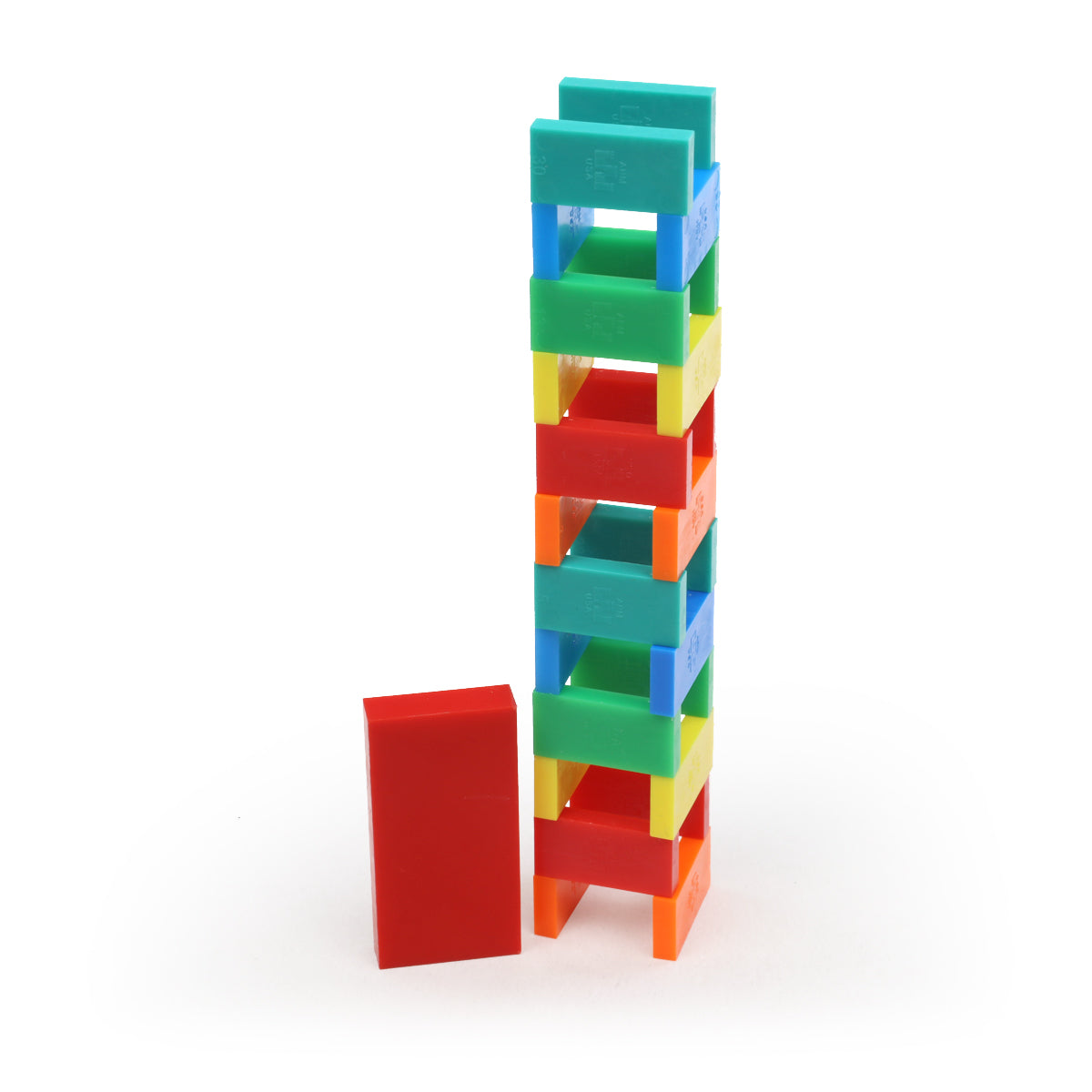 Multicolor Bulk Dominoes Mini Master Kit tower built with red, orange, yellow, green, blue, and teal Mini Dominoes stacked with a knockdown domino beside it.
