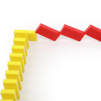 Lightning bolt zigzag pattern built from yellow and red Bulk Dominoes Mini Dominoes, demonstrating creative chain reaction designs from the Mini Master Kit.