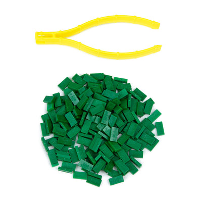 Atwood Toys World Record Mini Micro Dominoes in classic green piled together with yellow precision tweezer setup tool for tiny domino toppling challenges