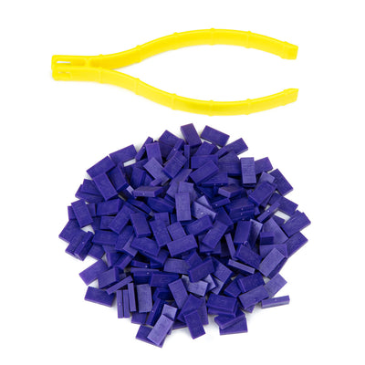 Atwood Toys World Record Mini Micro Dominoes in purple piled together with yellow precision tweezer setup tool for micro-scale domino builds and toppling