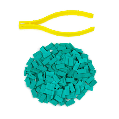 Atwood Toys World Record Mini Micro Dominoes in teal piled together with yellow precision tweezer setup tool for tiny domino toppling and precision builds