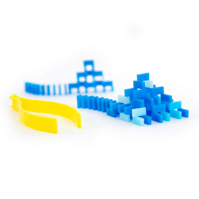 Atwood Toys World Record Mini Micro Dominoes feature shot with blue dominoes arranged in a small pyramid and chain reaction setup alongside a yellow setup tool