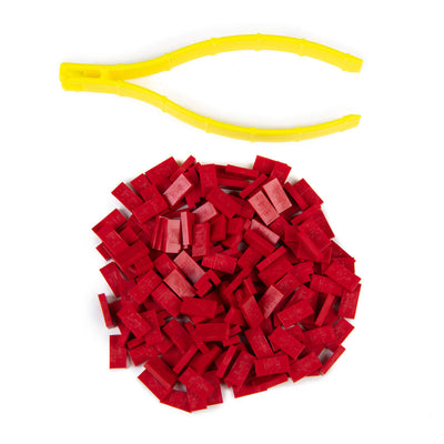 Atwood Toys World Record Mini Micro Dominoes red toppling dominoes piled together with yellow precision tweezer tool for placement and setup