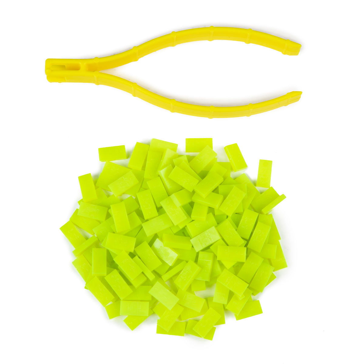 Atwood Toys World Record Mini Micro Dominoes in sour apple green piled together with yellow precision tweezer setup tool for micro-scale domino art