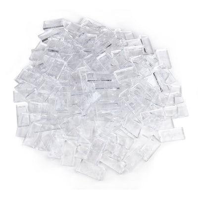 Bulk Dominoes Clear Pro Dominoes from Atwood Toys, a pile of clear full-weight toppling dominoes for chain reactions and domino art.