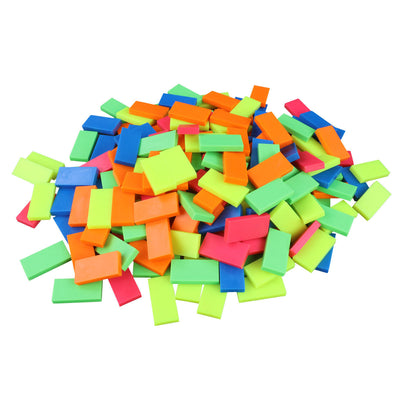 Bulk Dominoes Neon Mix Pro Dominoes from Atwood Toys, a vibrant pile of neon blue, orange, pink, green, and yellow full-weight toppling dominoes for chain reactions and domino art.