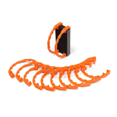 Bulk Dominoes Domino Arcs in orange, 12 interlocking chain reaction clips spread in a fan with two clipped onto a black Pro Domino showing how they attach