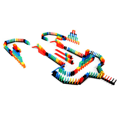 Atwood Toys Bulk Dominoes Rapid Track Kit setup featuring multi-color dominoes, red staircase bridges, blue spinners, and Domino Arcs arranged in a flowing chain reaction layout