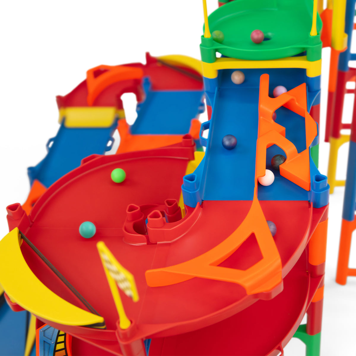 IMR Speedway Overdrive close-up of red curved divider and spiral section with marbles rolling through colorful multi-level track