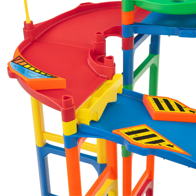 IMR Speedway Overdrive curved wedge drop-off section close-up showing red elevated turn with yellow hazard inserts on blue and green support frame