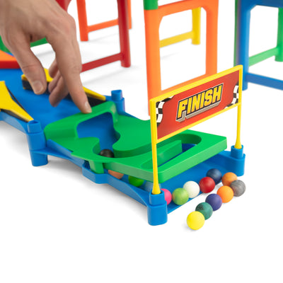 IMR Speedway Overdrive finish line gate with hand placing marble on track and colorful marbles collected at the base
